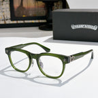 Green eyeglass frames with silver hardware and fleur-de-lis side accents