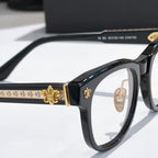 Black eyeglass frame with gold bar ornament and clear lenses