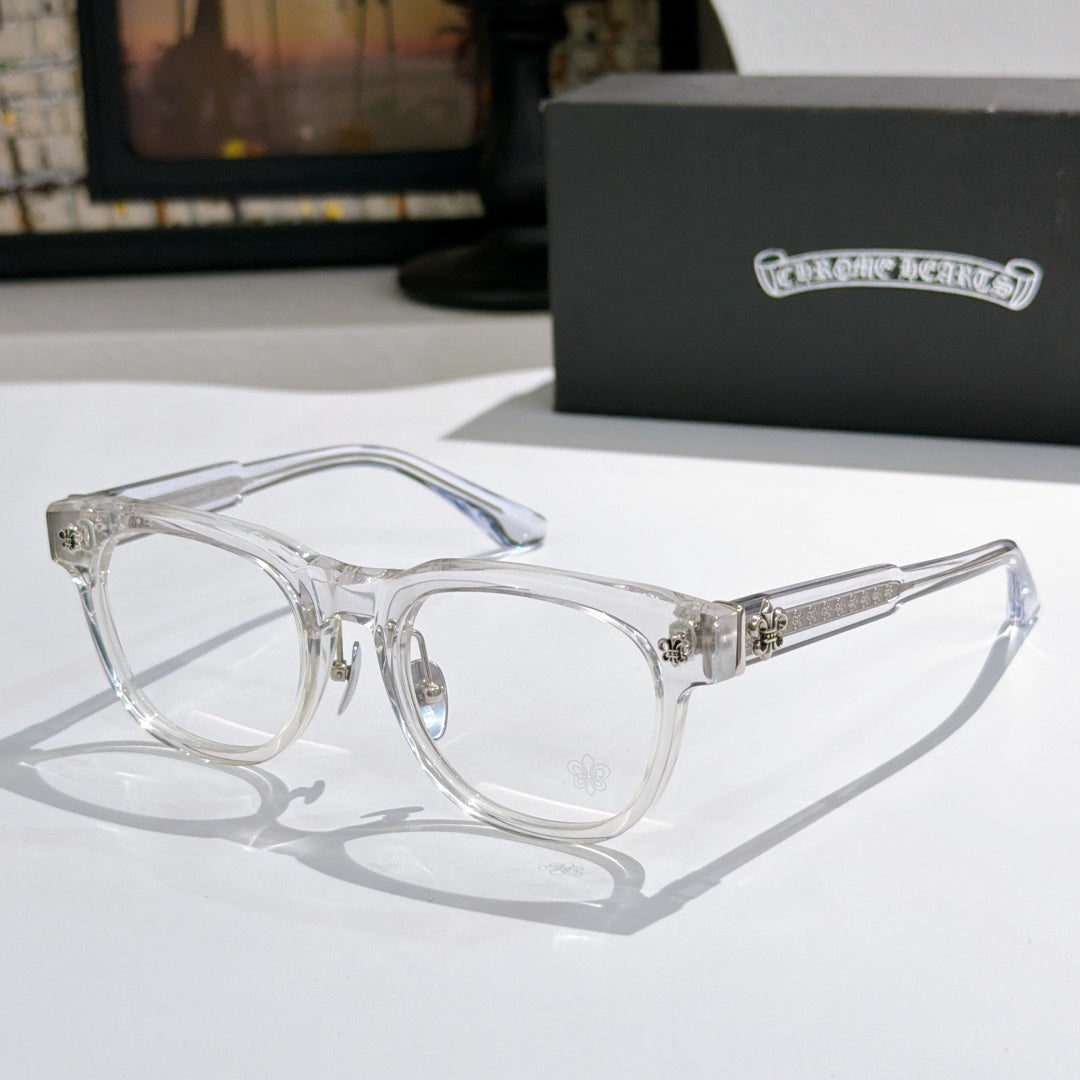 Clear eyeglass frames with silver ornate hinges and clear lenses