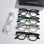 Set of eyeglass frames in blue, green, clear, and black with clear lenses
