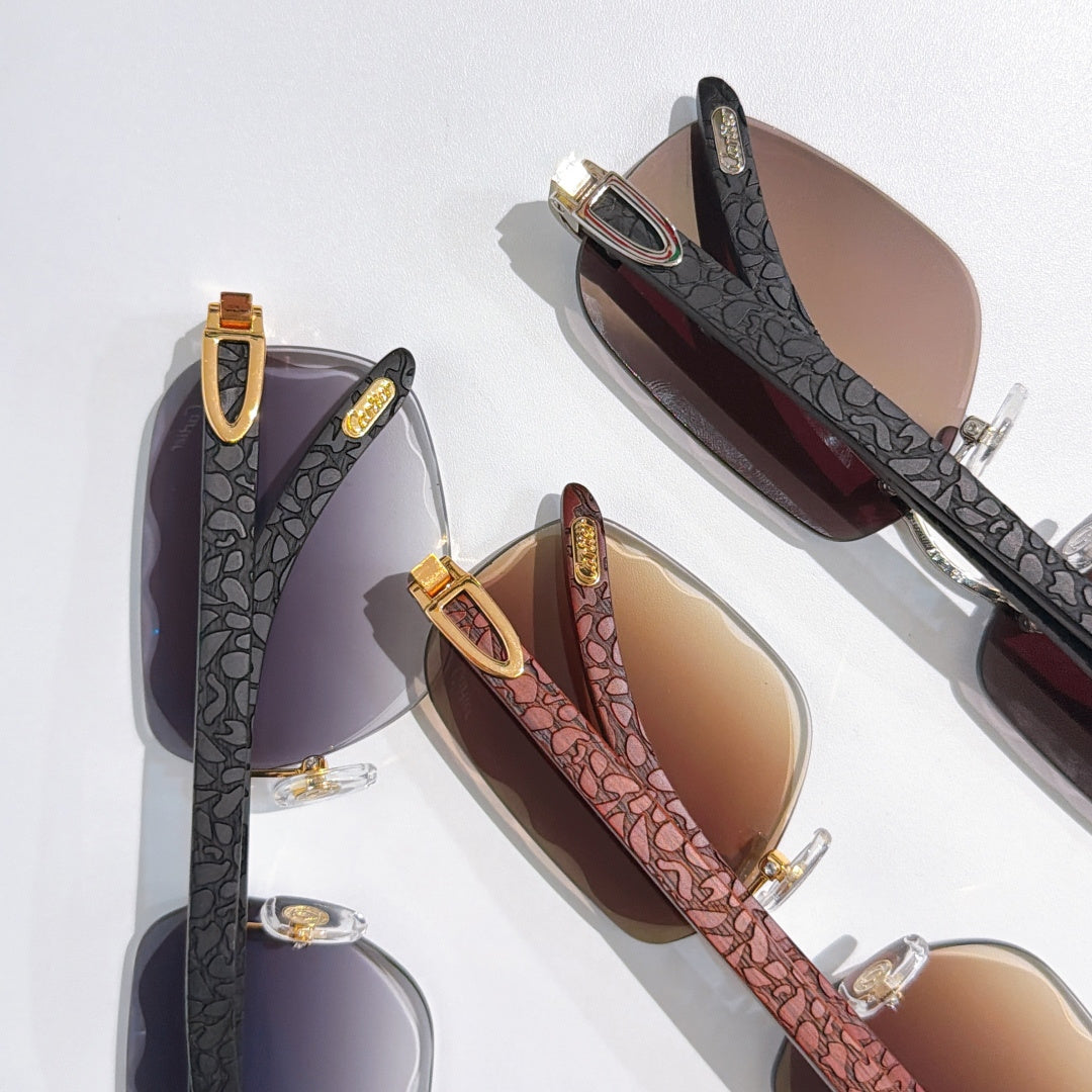 Two pairs of patterned temple sunglasses with gold-tone hinges and tinted lenses