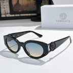 Black cat-eye sunglasses with round lenses and gold emblem on the temple