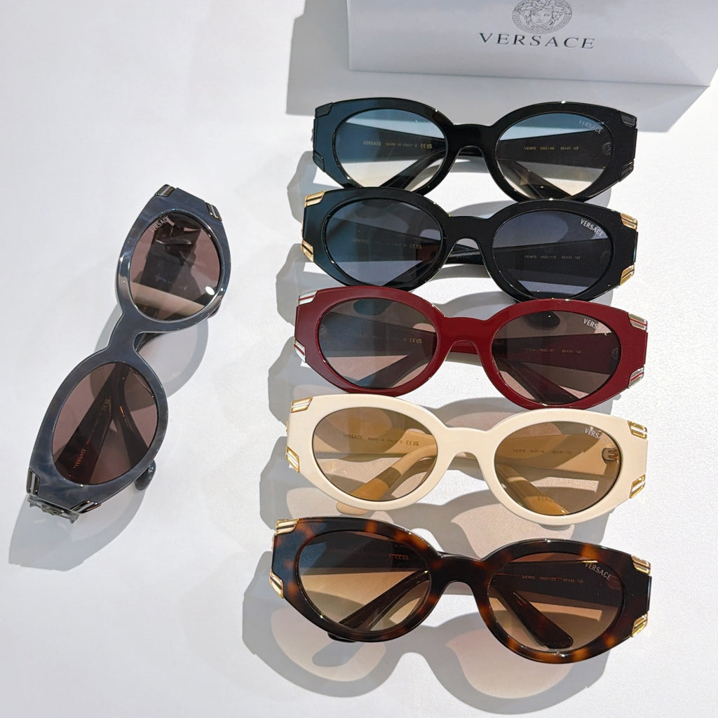Assorted sunglasses: black, blue, red, cream, and tortoiseshell with emblem temples