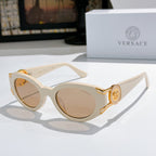 Cream cat-eye sunglasses with round lenses and gold emblem on the temple