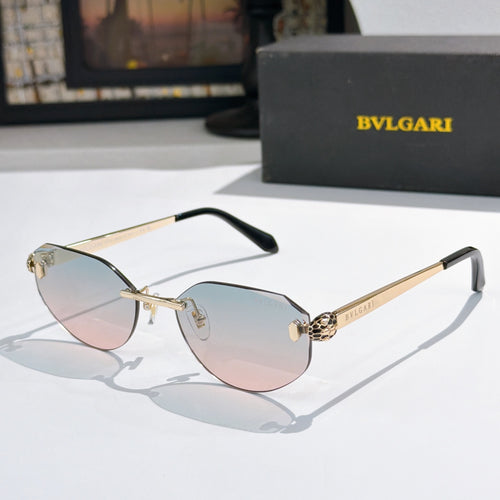 Gold-tone metal sunglasses with light pink gradient lenses, cat-eye shape, logo temples