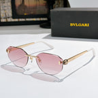 Gold-tone metal sunglasses with pink gradient lenses, cat-eye frame, logo at temples