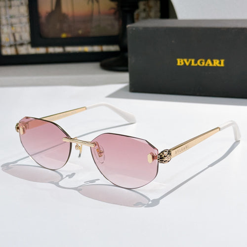 Gold-tone metal sunglasses with pink gradient lenses, cat-eye frame, logo at temples