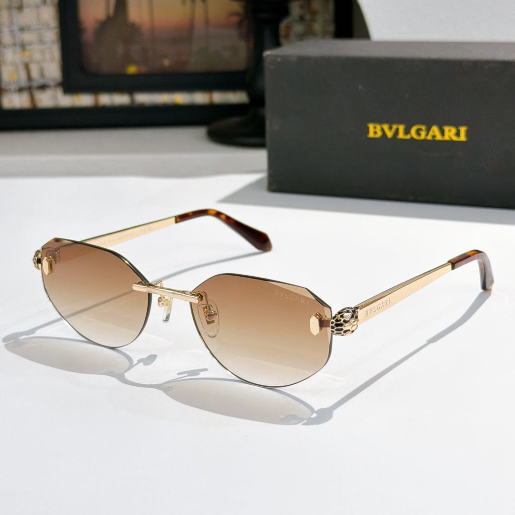 Gold-tone metal sunglasses with tan gradient lenses, cat-eye frame, tortoise arms, logo