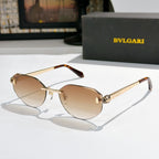 Gold-tone metal sunglasses with tan gradient lenses, cat-eye frame, tortoise arms, logo