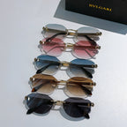 Stacked set of gold-tone sunglasses with tinted lenses in pink, blue, brown, and black hues
