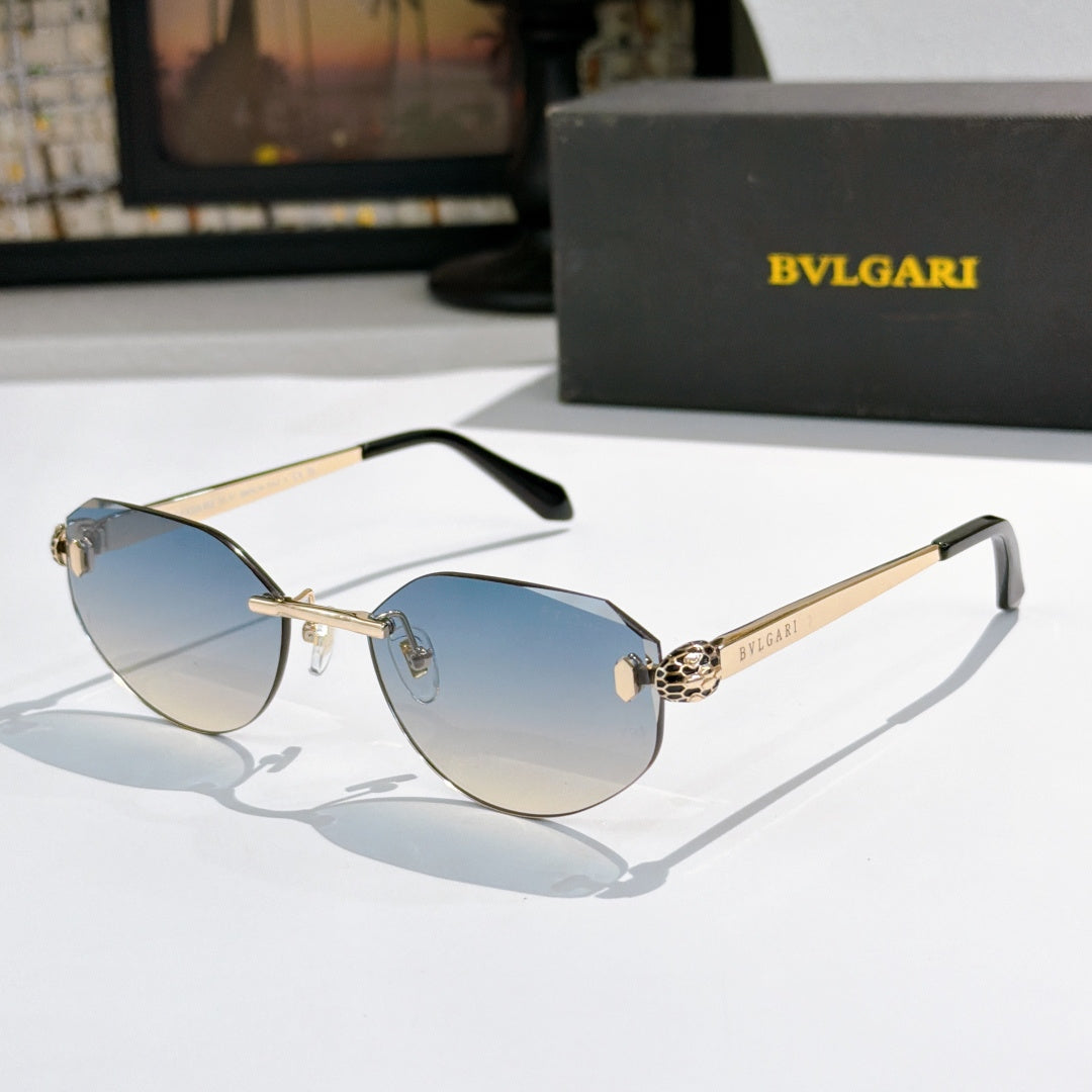 Gold-tone metal sunglasses with blue gradient lenses, cat-eye frame, logo at temples