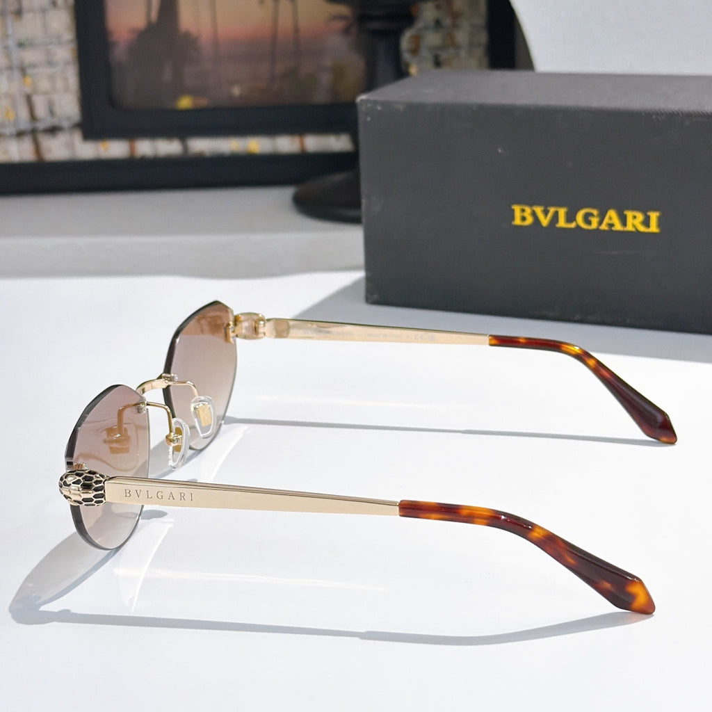 Gold-tone sunglasses with tan gradient lenses and tortoise arms, cat-eye frame view
