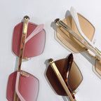 Bvlgari sunglasses display with pink, brown, and red-tinted lenses on gold-tone frames