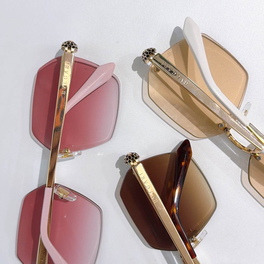 Bvlgari sunglasses display with pink, brown, and red-tinted lenses on gold-tone frames
