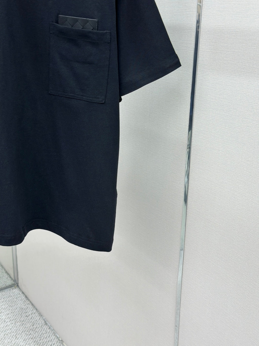 Dark navy T-shirt hem and pocket corner, short sleeves