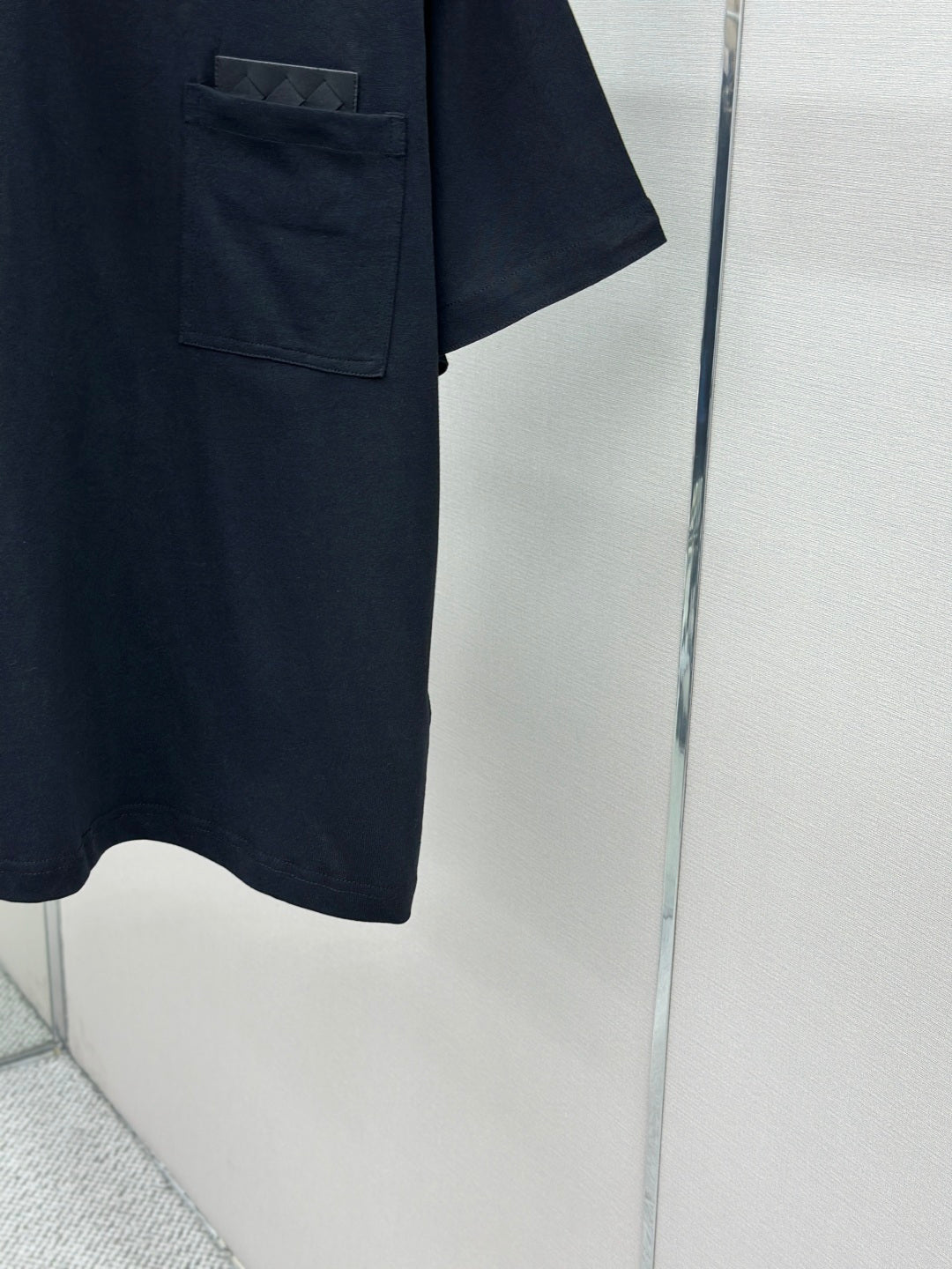 Dark navy T-shirt hem and pocket corner, short sleeves