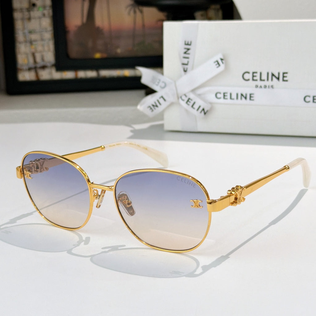 Gold-tone round sunglasses with blue-tinted lenses and gold emblem on temple