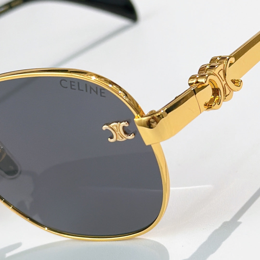 Gold-tone round sunglasses close-up with CELINE logo on lens and temple