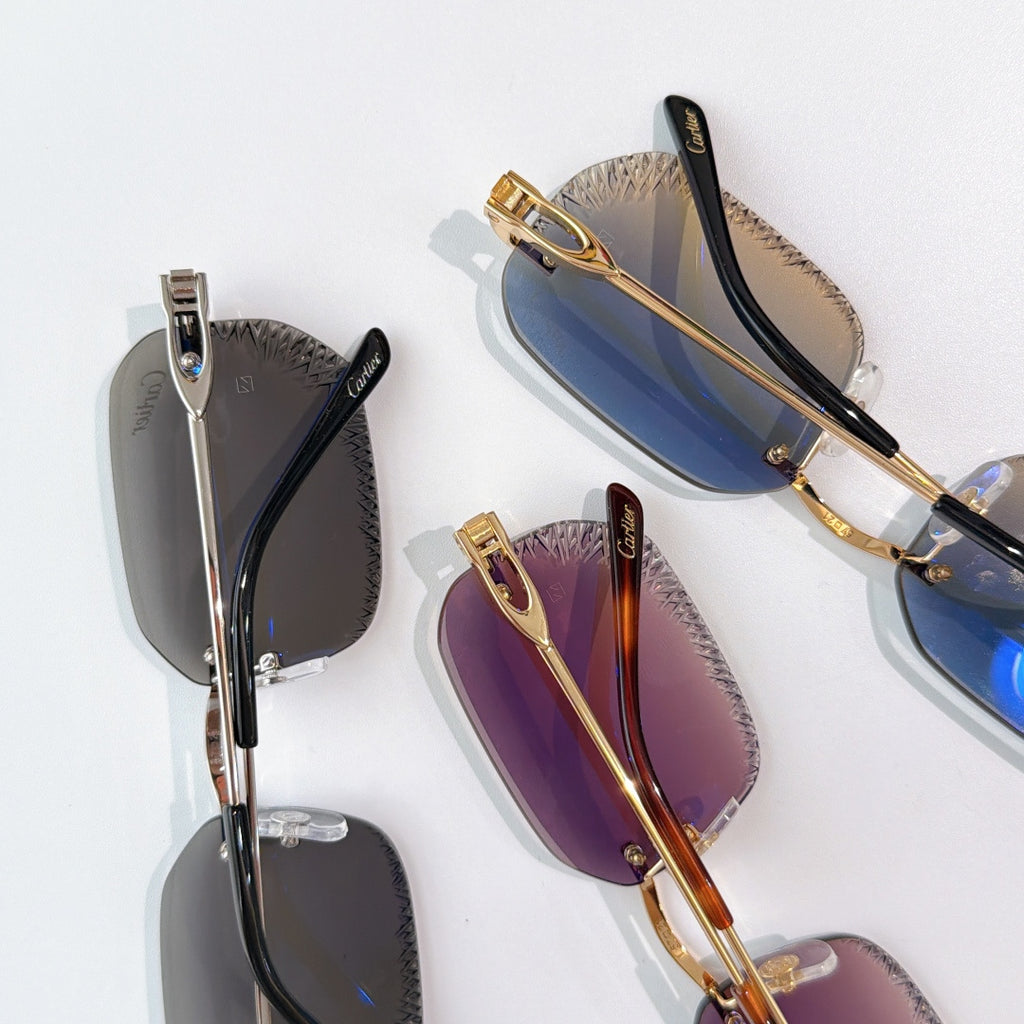 Cartier sunglasses, close-up of multiple frames with blue, purple, and black lenses.