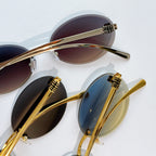 Sunglasses close-up with gold metal round frames and assorted dark tinted lenses.