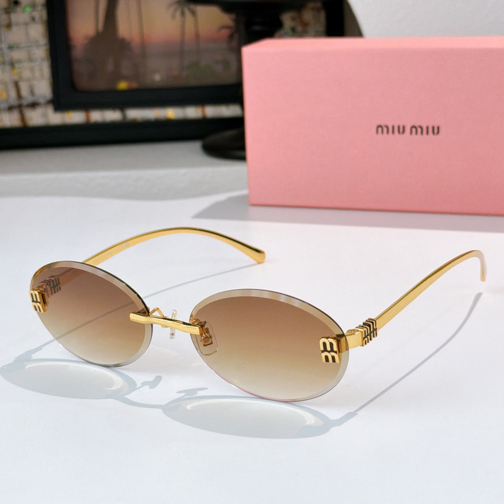 Sunglasses with gold metal round frames and tan gradient lenses.