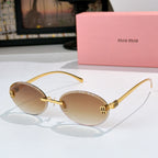 Sunglasses with gold metal round frames and tan gradient lenses.