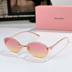 Sunglasses with gold metal round frames and pink gradient lenses.