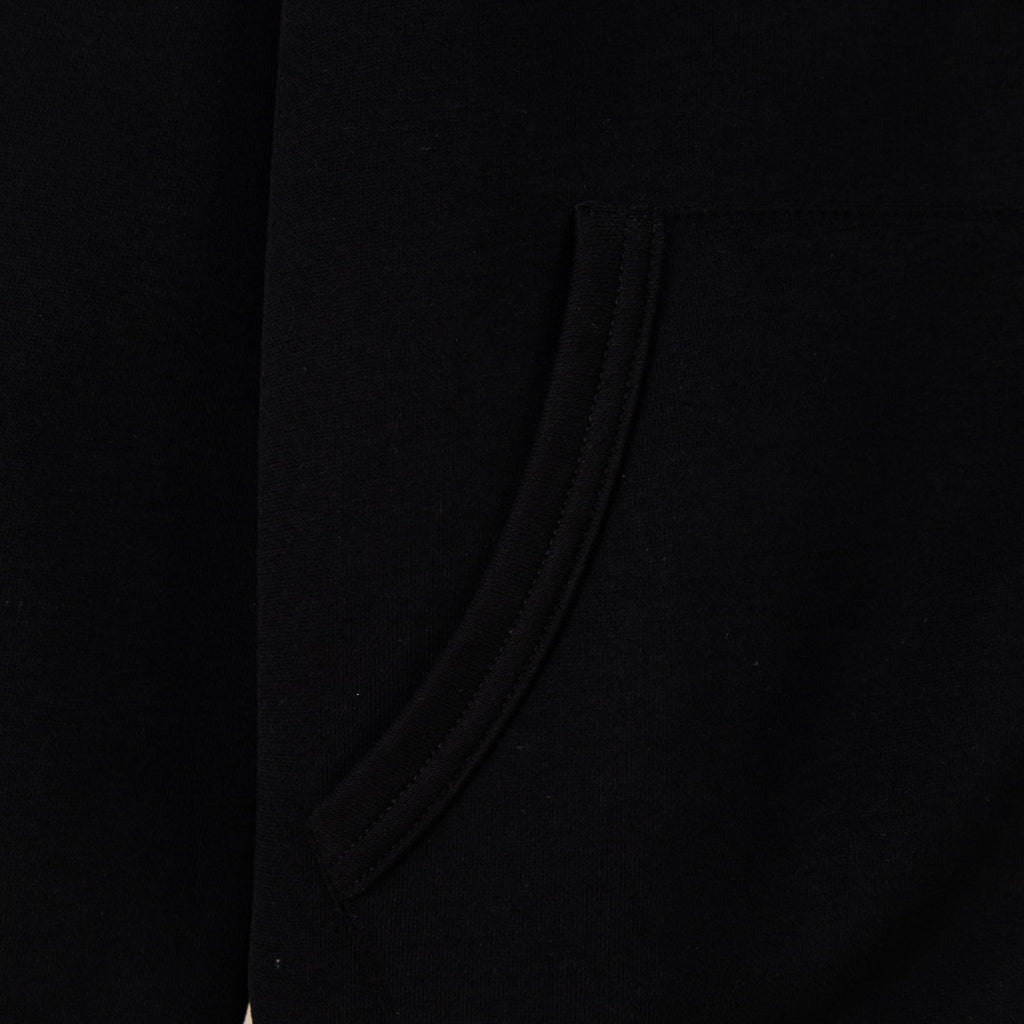 Black hoodie side view with smooth fabric and curved seam near pocket