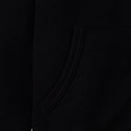 Black hoodie side view with smooth fabric and curved seam near pocket