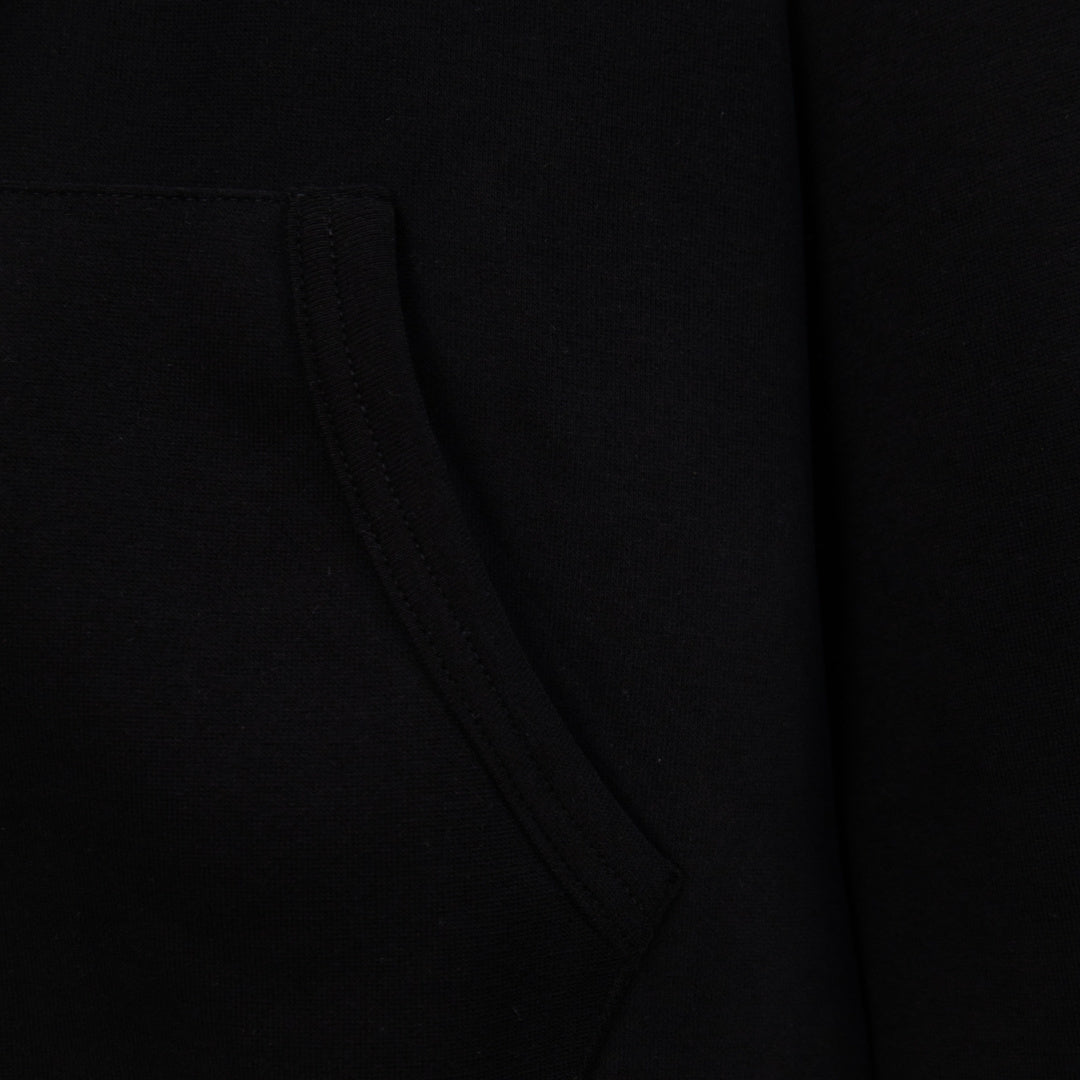 Black hoodie detail of diagonal seam and pocket line at midsection