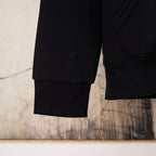 Black hoodie lower sleeve with ribbed cuffs at wrist