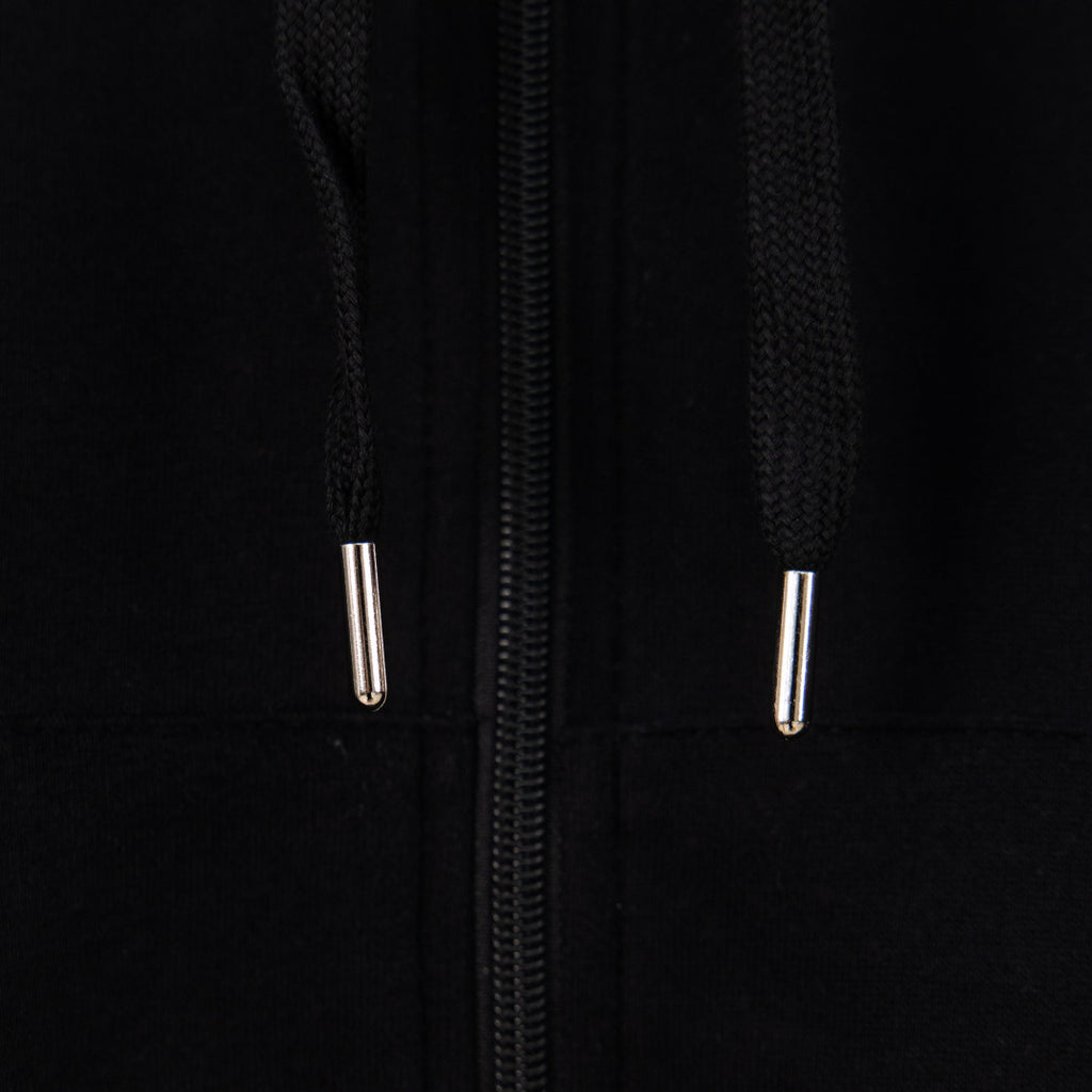 Black hoodie close-up of two silver zipper pulls on the front opening