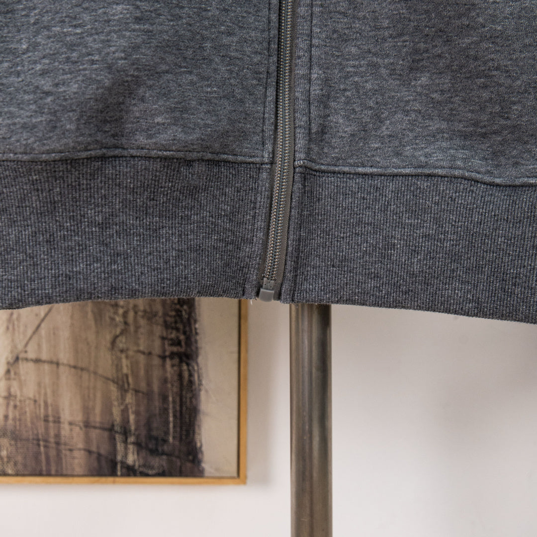Heather gray hoodie hem with front zipper and stitched waistband seam