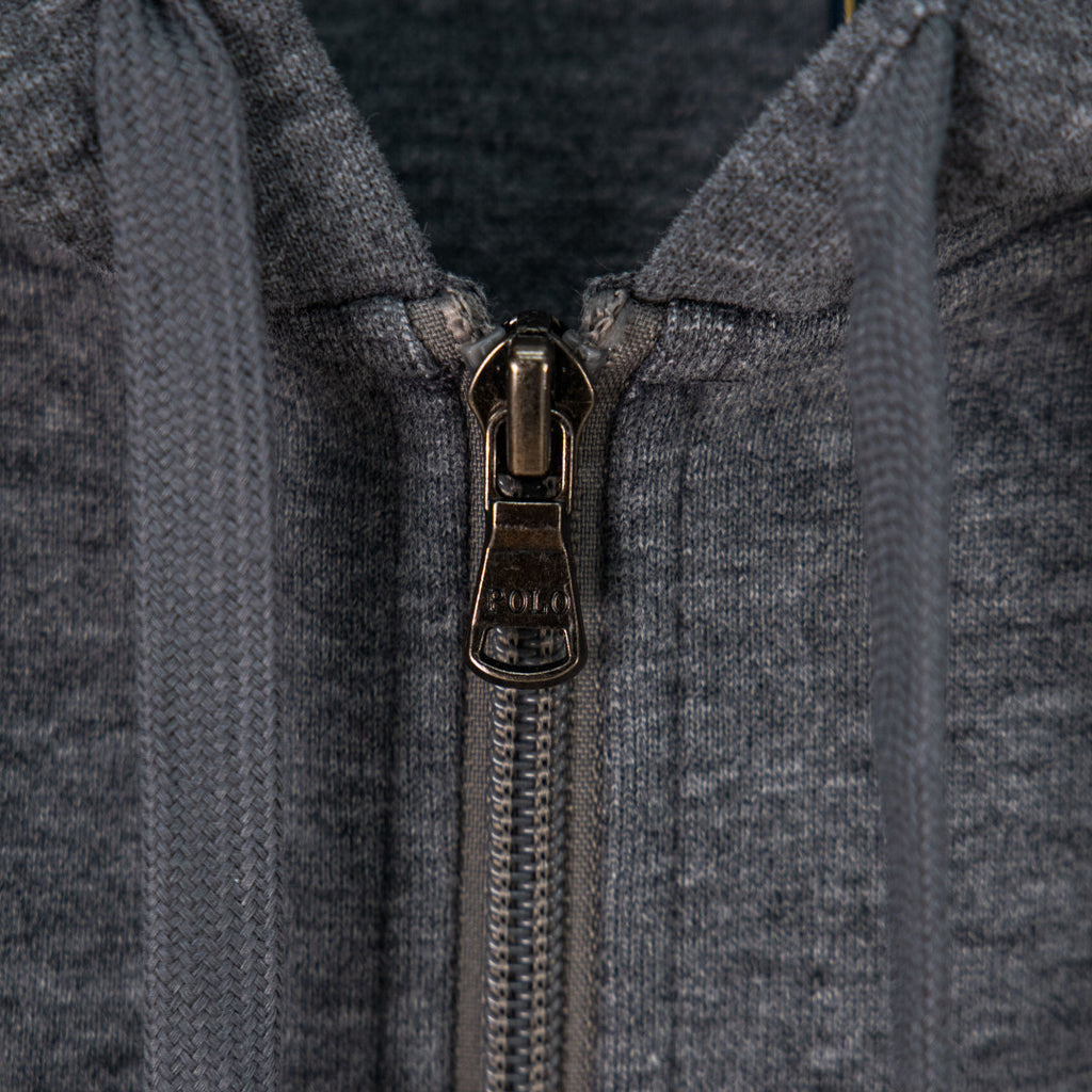 Zip-up hoodie front with metal zipper pull and hood opening