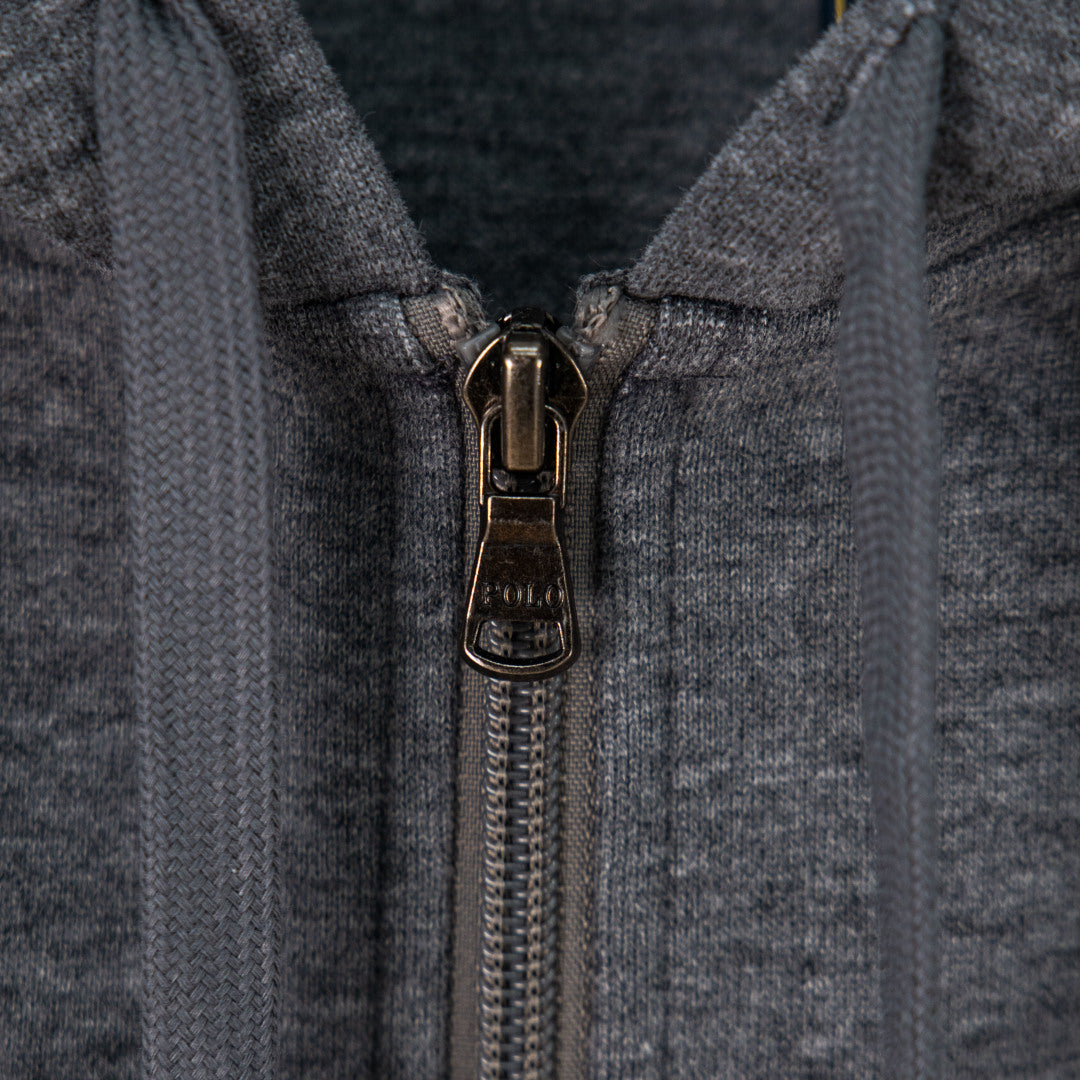 Zip-up hoodie front with metal zipper pull and hood opening