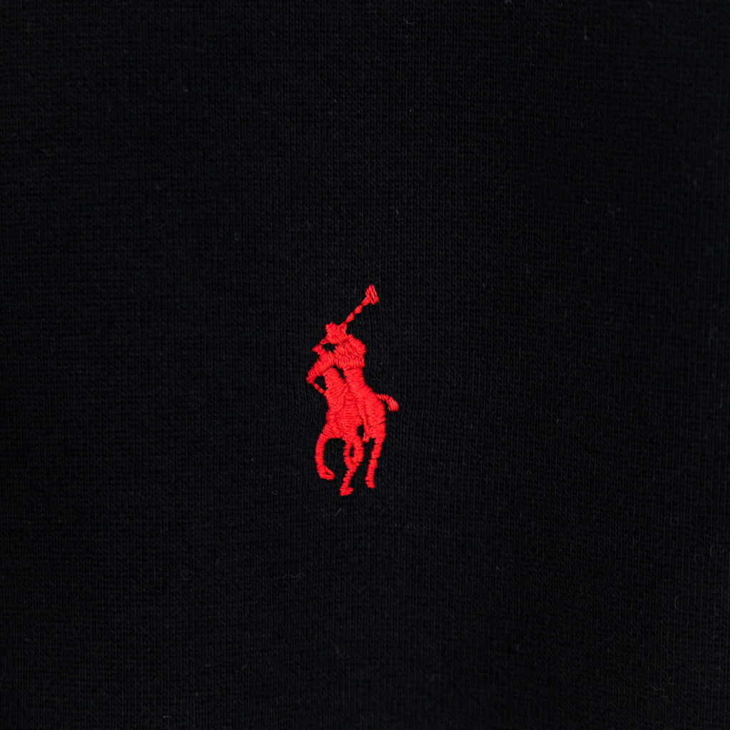 Black hoodie with small red polo logo on chest
