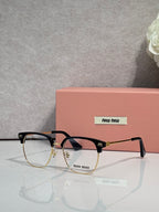 MiuMiu eyeglasses with black full-rim frame and tortoiseshell temples, clear lenses