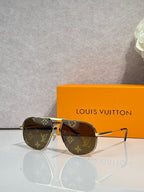 Louis Vuitton sunglasses with gold-tone frame, dark lenses, LV monogram accents
