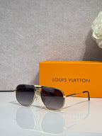 Louis Vuitton sunglasses with gold-tone frame and dark tinted lenses, monogram pattern