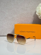 Louis Vuitton sunglasses with gold-tone bridge and dark lenses, monogram style frame