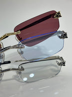 Gold-trim eyeglasses with maroon-tinted lens and clear lower lens
