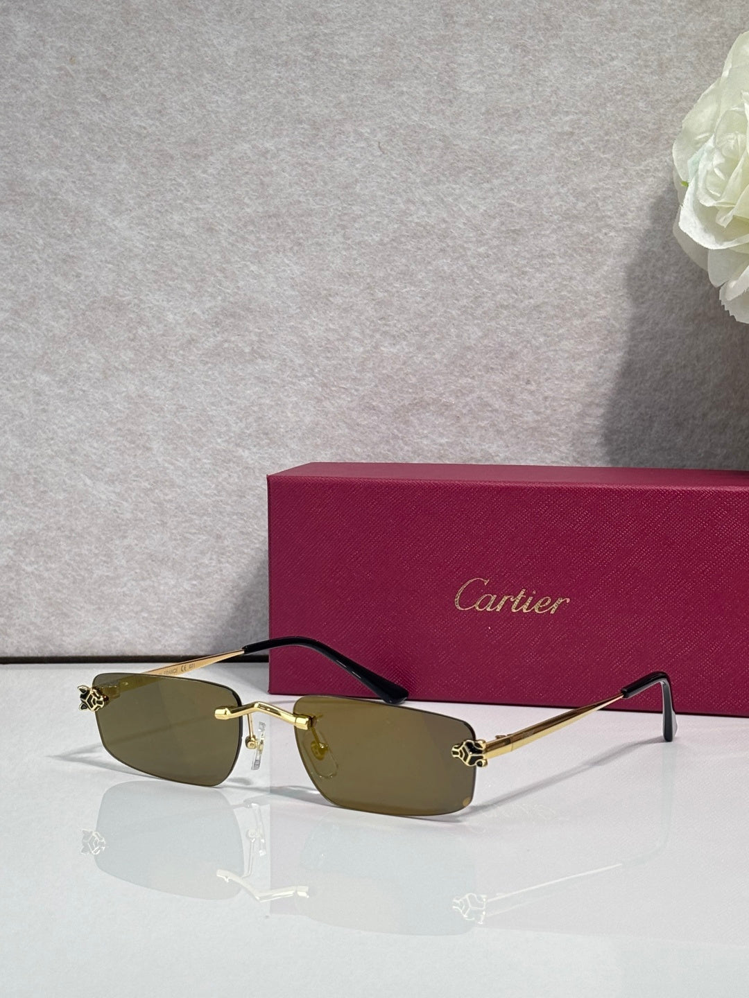 Metal-framed eyeglasses with olive-tinted lenses and thin black temples