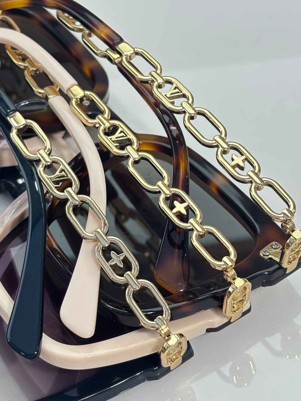 Louis Vuitton sunglasses gold chain temple detail with tortoiseshell accents