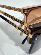 CHANEL sunglasses close-up: gold chain temples on rose and dark frames