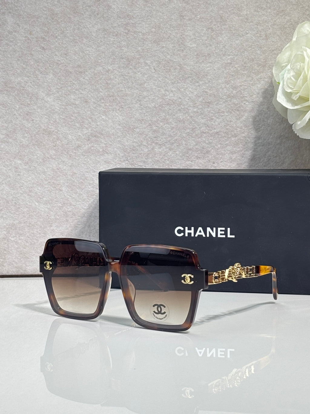 Chanel sunglasses with dark brown tortoise-effect square frames and gold-tone logo