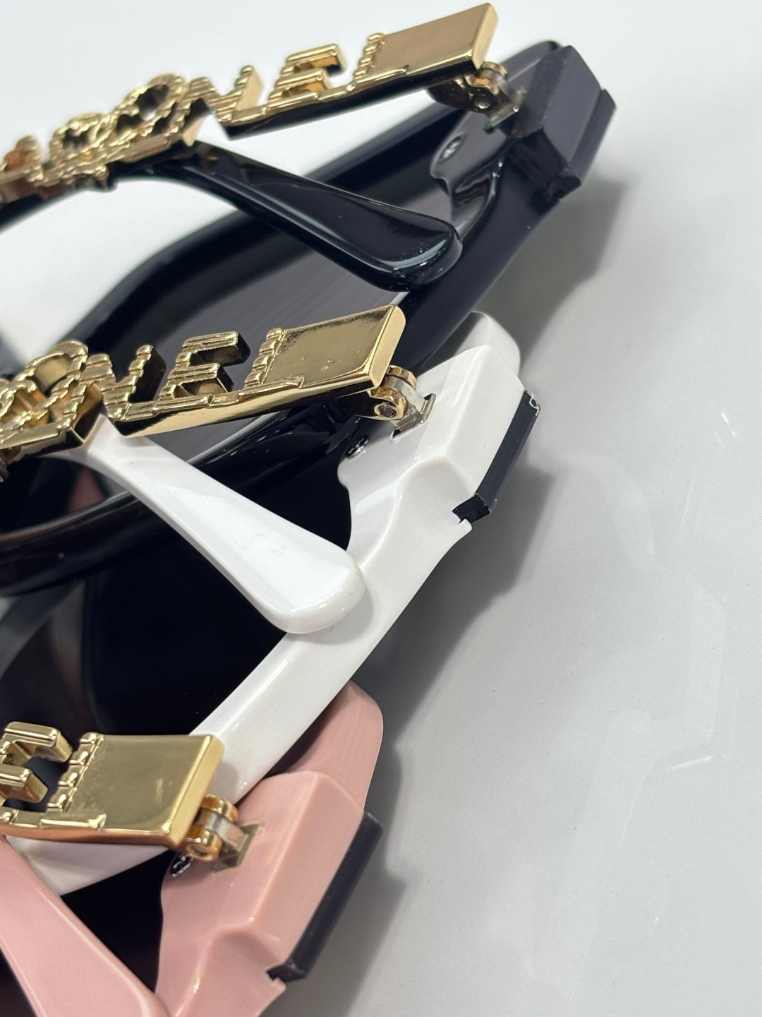 Chanel sunglasses close-up showing gold-tone temple detailing on frames
