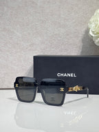 Chanel sunglasses with dark navy square frames and gold-tone logo hardware