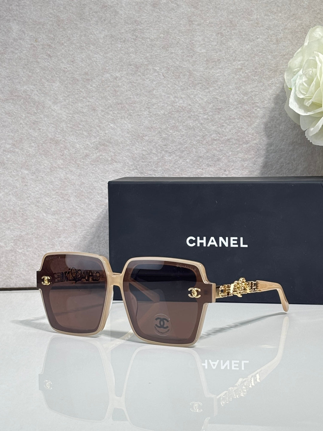 Chanel sunglasses with brown square frames and gold-tone logo hardware