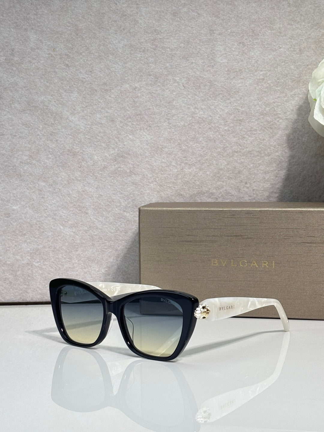 Bvlgari sunglasses, black frame with gradient dark lenses and gold hinge accents