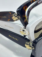 Bvlgari glasses, gold-tone hinge with blue enamel lion detail on dark arms